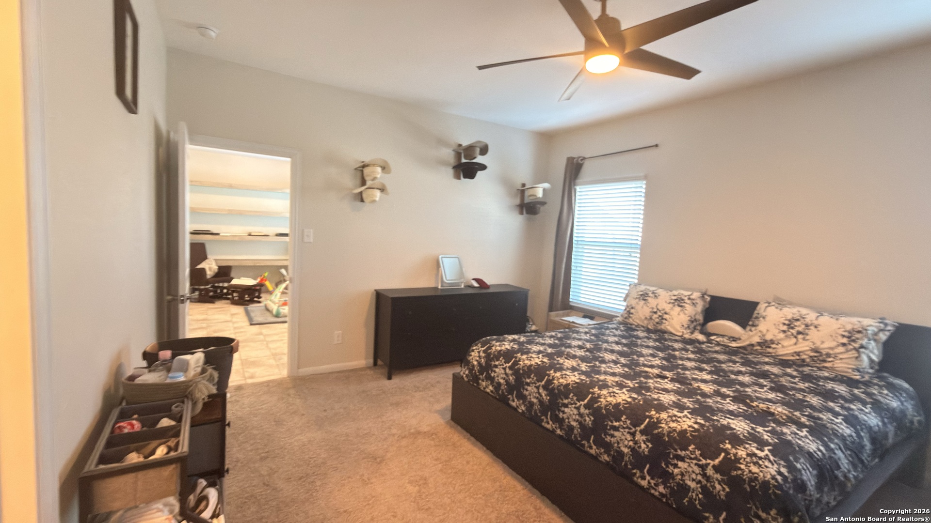 8949 Elizabeth Park Converse, TX 78109 - Photo 21 of 35 a bedroom with a bed and a dresser with rug