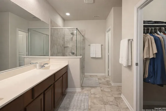 a bathroom with a double vanity sink a and a mirror