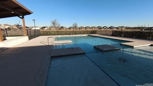a view of a swimming pool with a patio