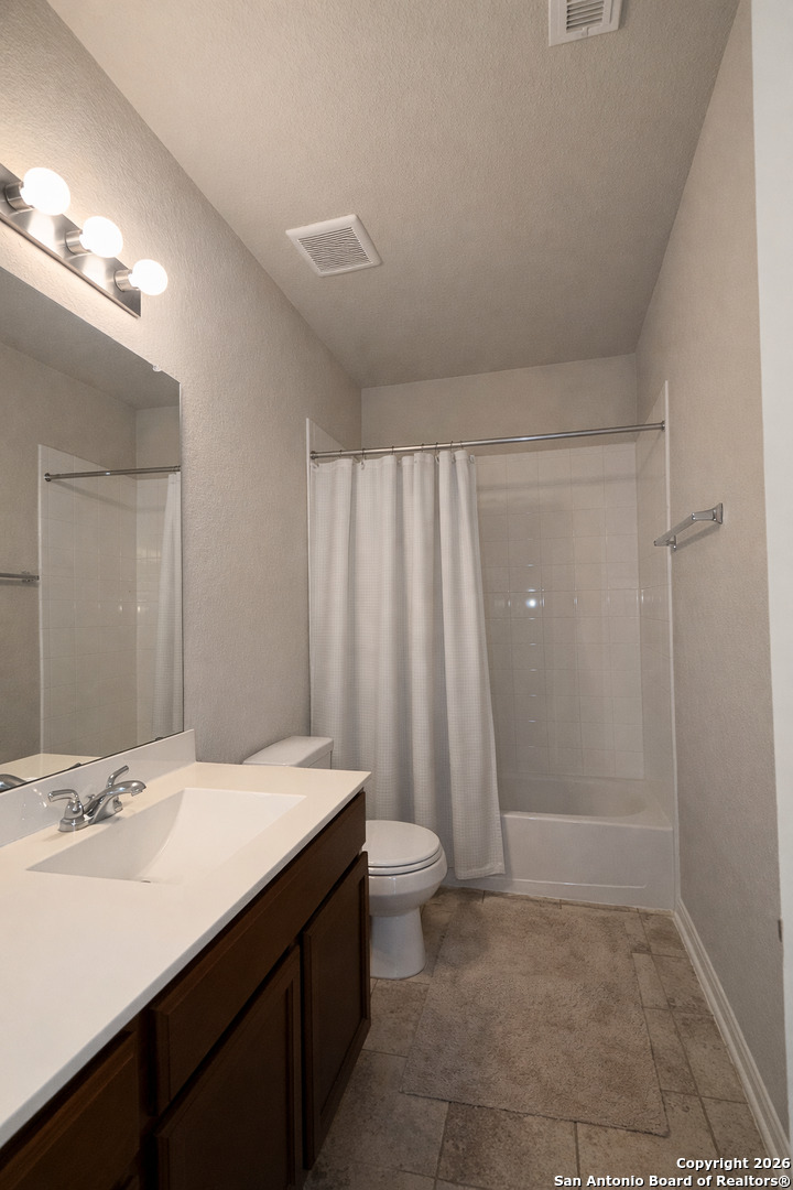 8949 Elizabeth Park Converse, TX 78109 - Photo 5 of 35 a bathroom with a sink a toilet and a mirror
