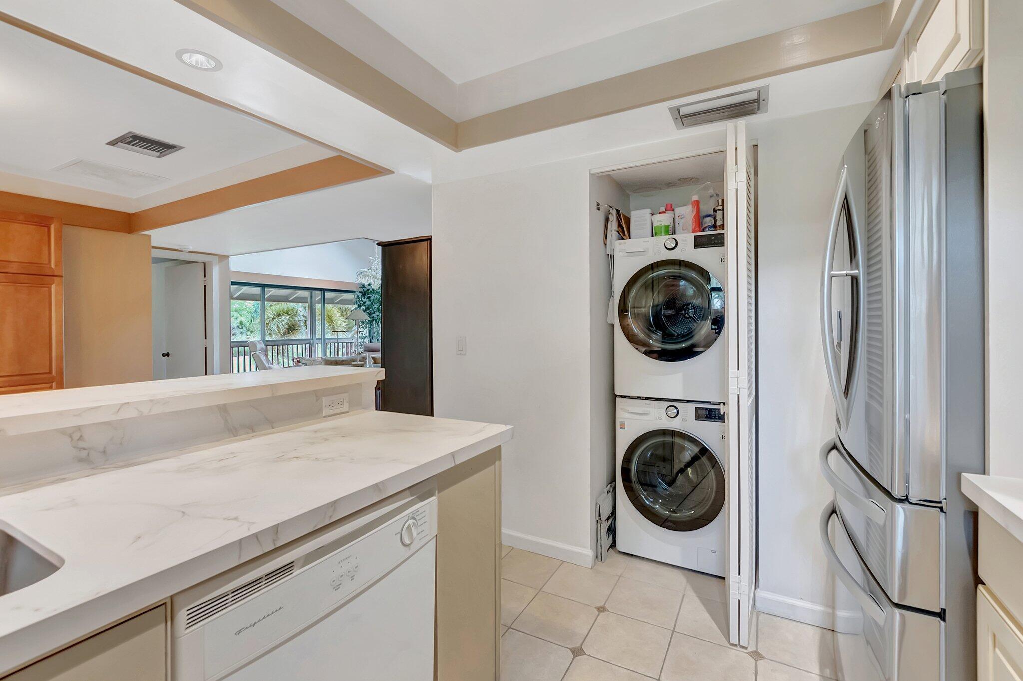 7067 Rain Forest Drive Boca Raton, FL 33434 - Photo 12 of 32 a view of a kitchen with washer and dryer