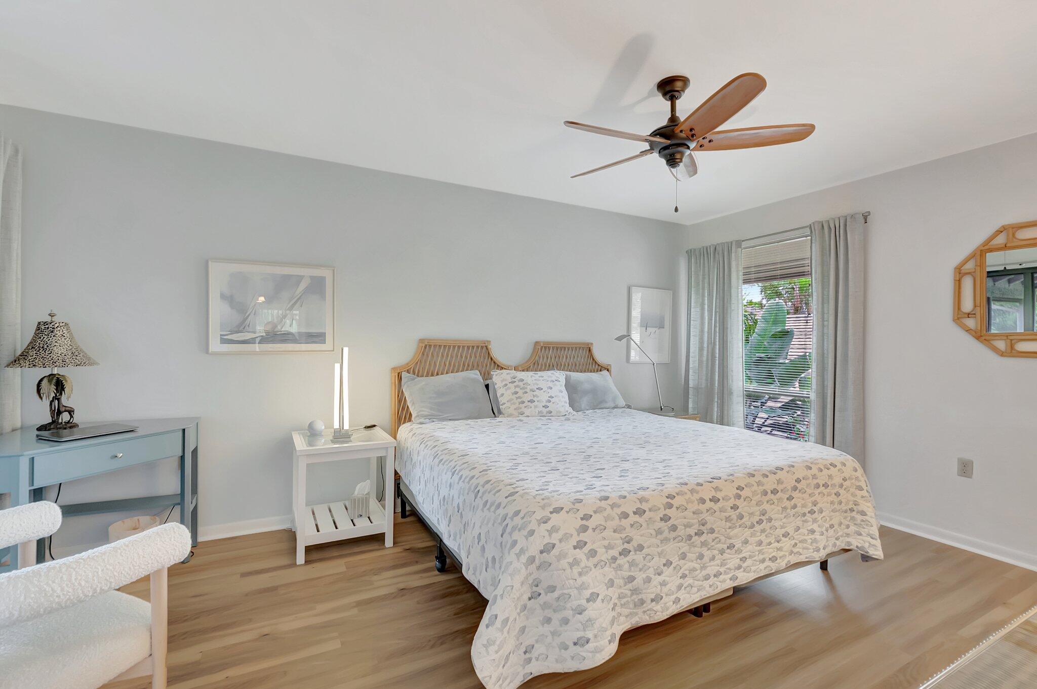 7067 Rain Forest Drive Boca Raton, FL 33434 - Photo 14 of 32 a bedroom with a bed and a chandelier