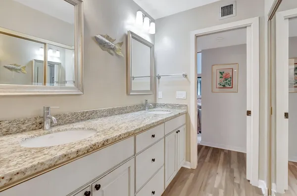 a bathroom with a granite countertop sink mirror and vanity