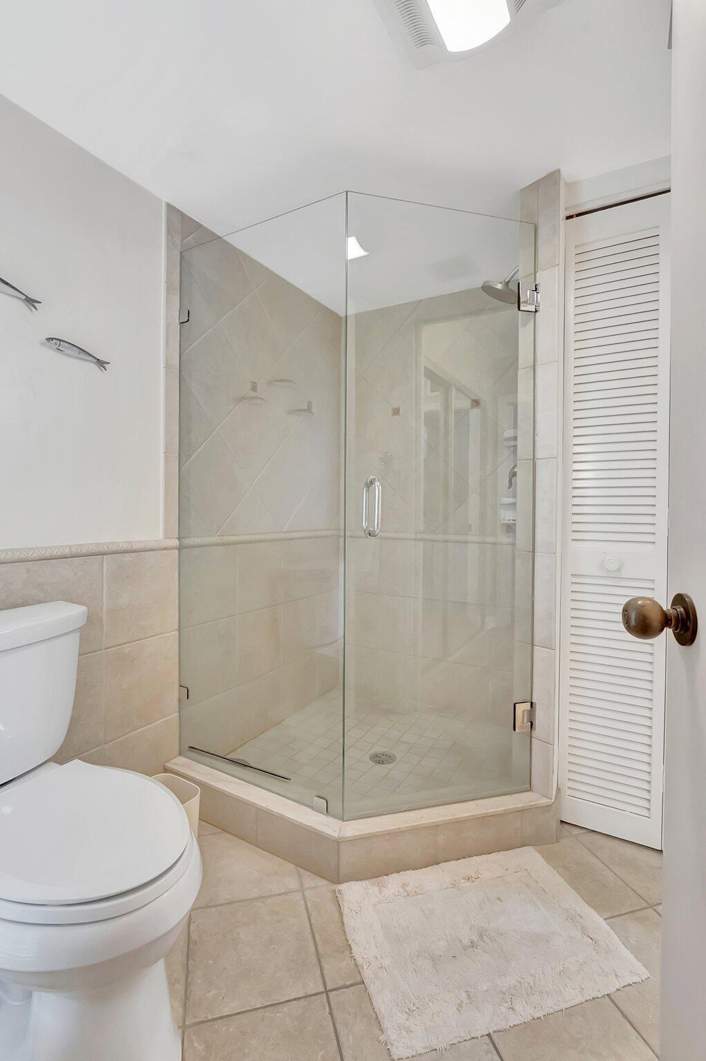 7067 Rain Forest Drive Boca Raton, FL 33434 - Photo 19 of 32 a bathroom with a shower and a toilet