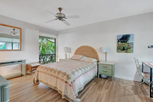 a bedroom with a bed a table and chair