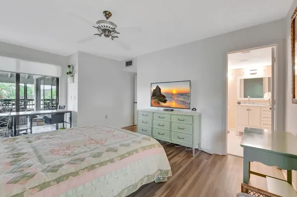 a bedroom with a bed and a dresser in it