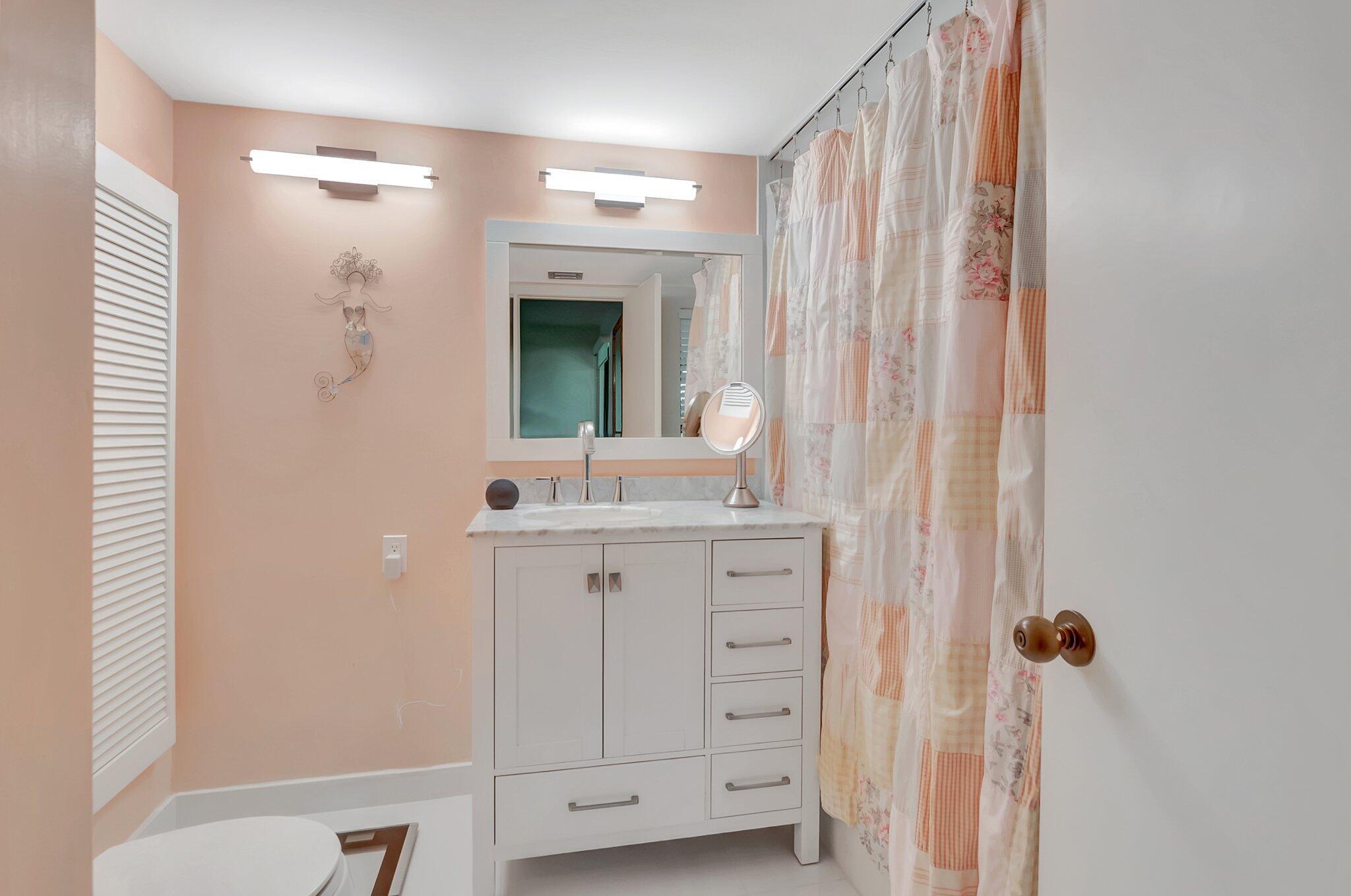 7067 Rain Forest Drive Boca Raton, FL 33434 - Photo 22 of 32 a bathroom with a double vanity sink and mirror