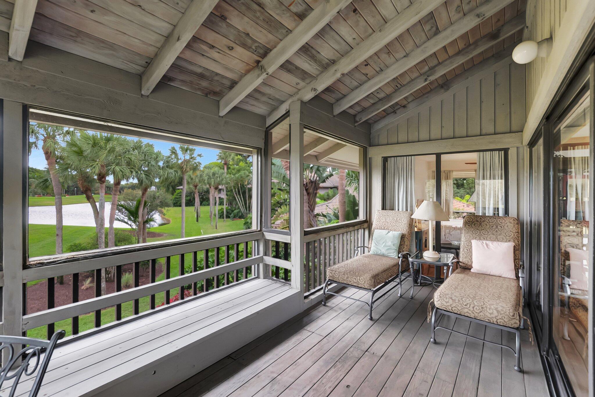 7067 Rain Forest Drive Boca Raton, FL 33434 - Photo 25 of 32 a balcony with wooden floor outdoor seating and furniture