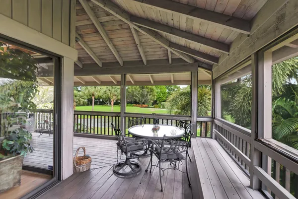 a view of a chairs and table in the balcony