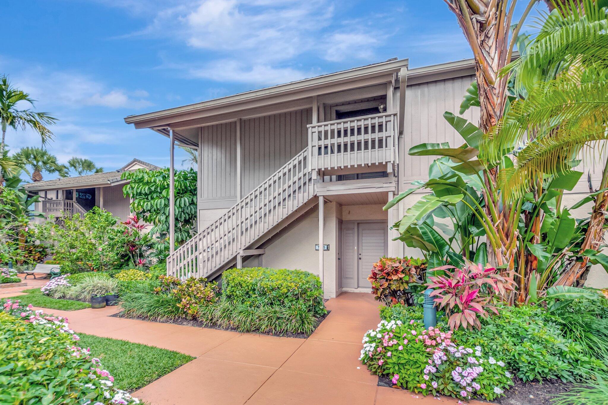 7067 Rain Forest Drive Boca Raton, FL 33434 - Photo 31 of 32 a front view of small house with a garden