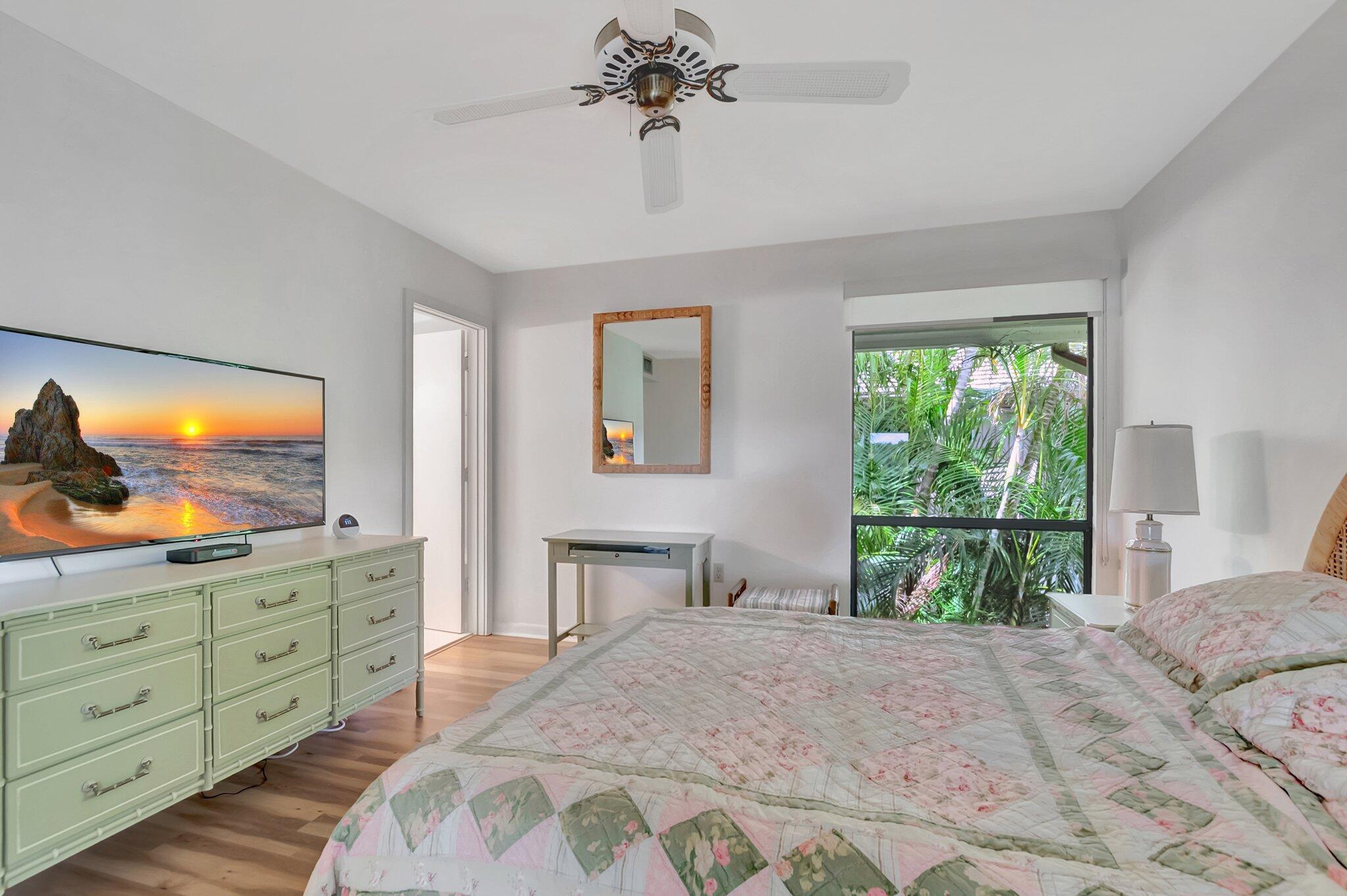 7067 Rain Forest Drive Boca Raton, FL 33434 - Photo 4 of 32 a bedroom with a bed and a flat tv screen on dresser