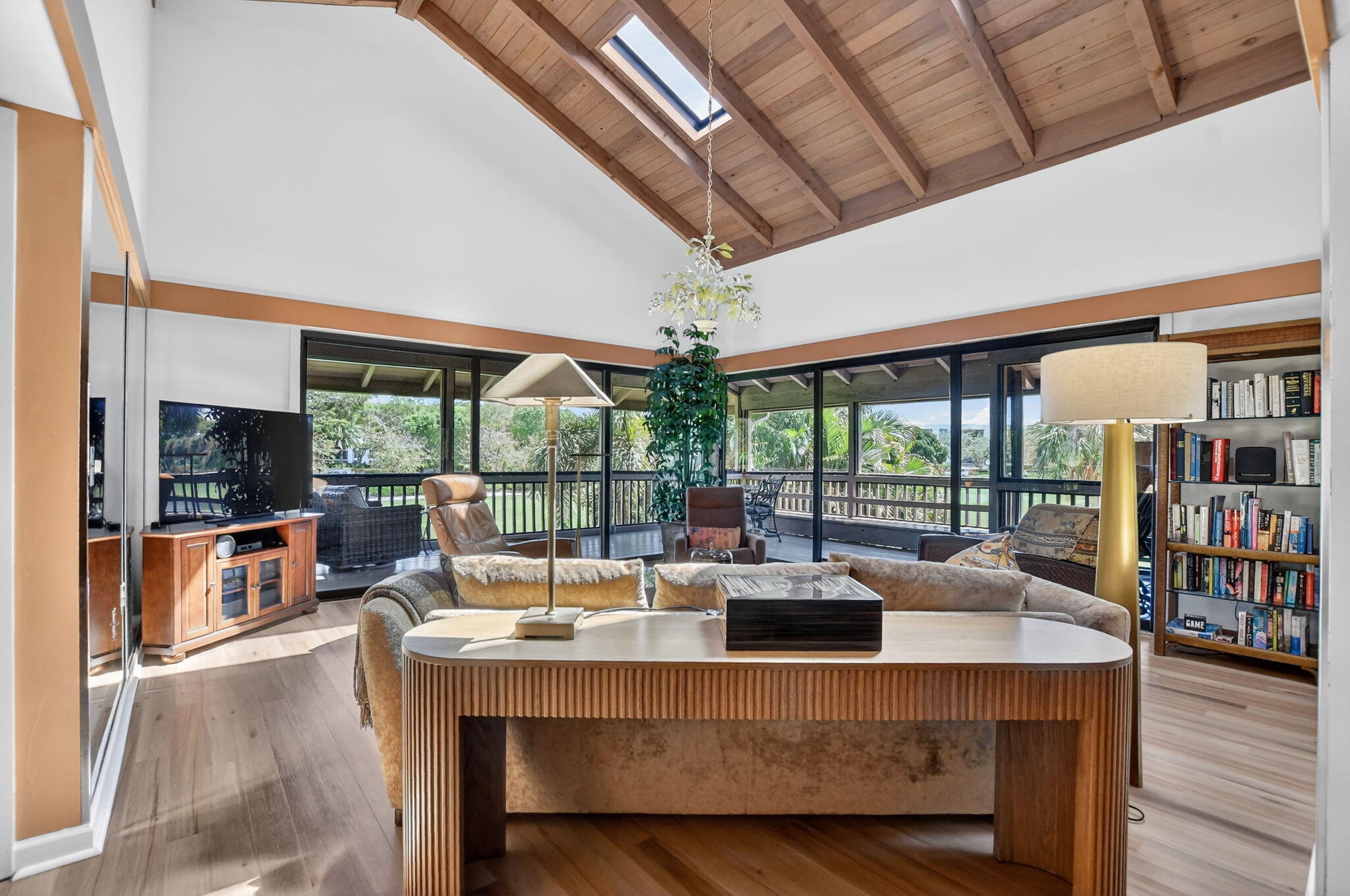 7067 Rain Forest Drive Boca Raton, FL 33434 - Photo 7 of 32 a living room with furniture a flat screen tv and floor to ceiling windows