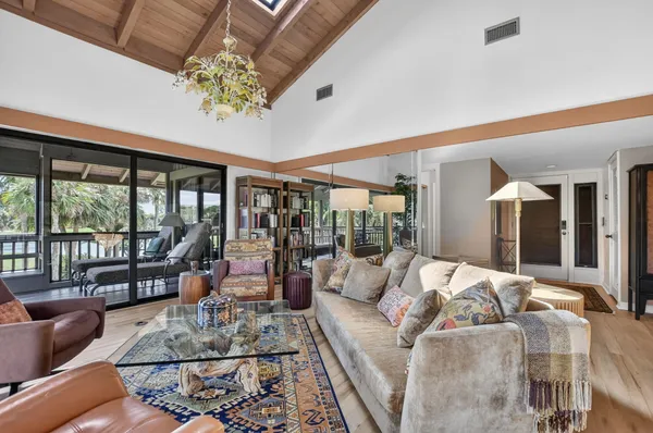 a living room with furniture and large windows