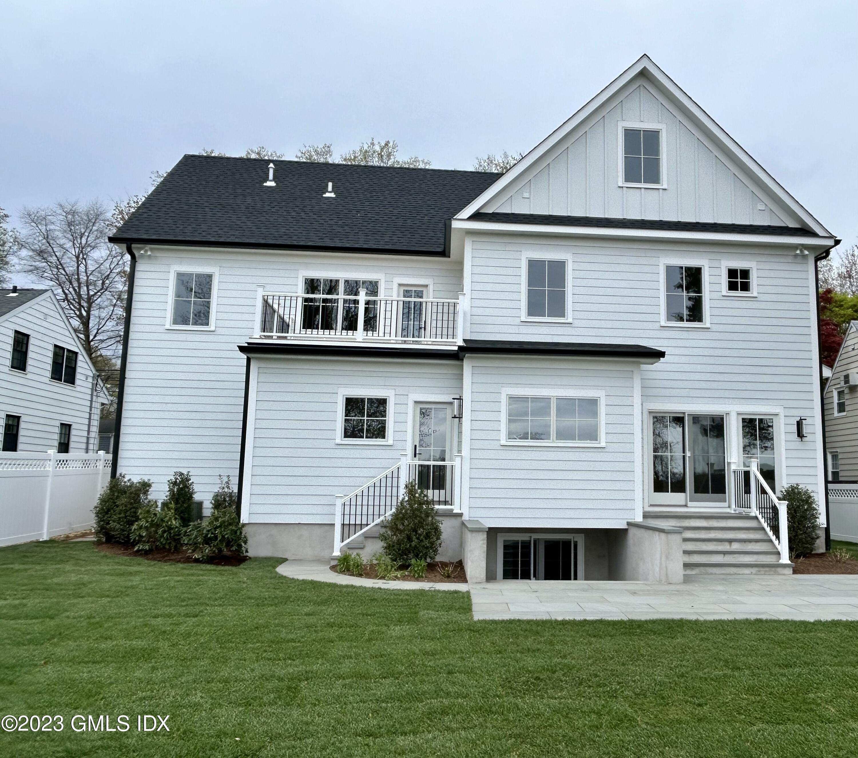 73 Sheep Hill Road Riverside, CT 06878 - Photo 2 of 3 a front view of a house with a yard