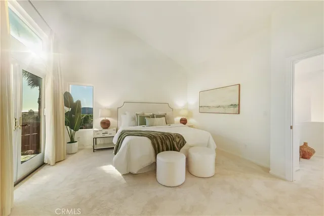 a bedroom with a bed and a large mirror