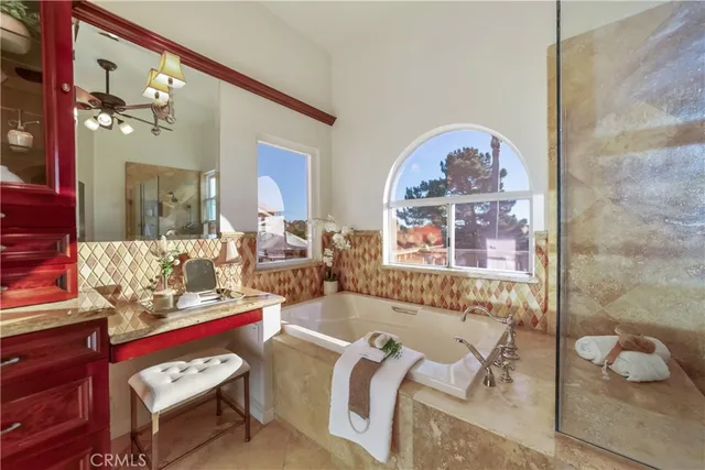 a bathroom with a granite countertop sink and a large mirror