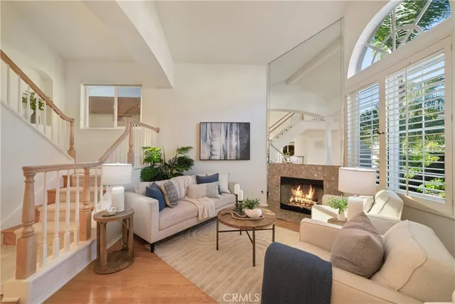 a living room with furniture fireplace and a large window