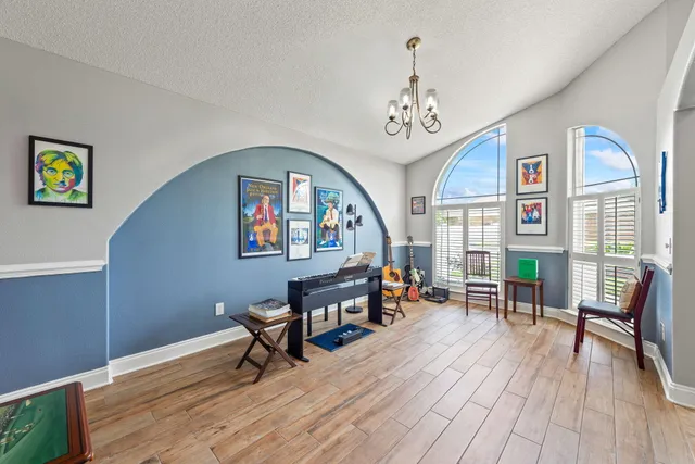 a kitchen with stainless steel appliances granite countertop a refrigerator a stove and a sink with cabinets