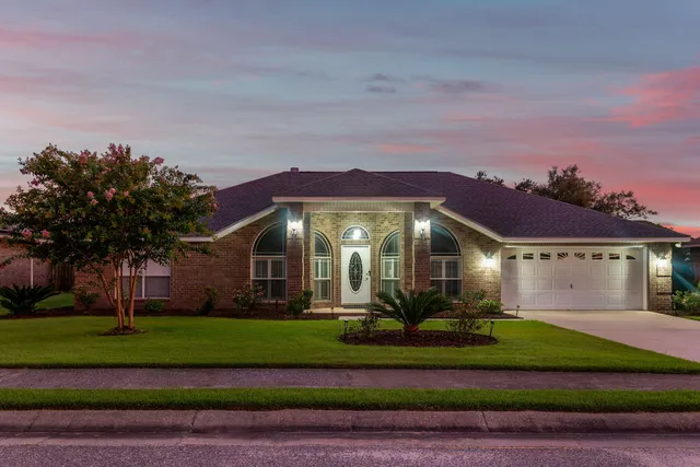 a kitchen with stainless steel appliances granite countertop wooden cabinets a stove top oven a sink and dishwasher