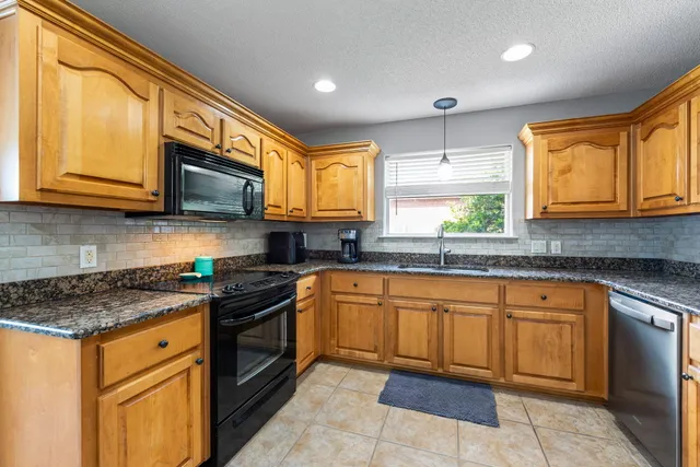 a dining room with furniture a rug and wooden floor