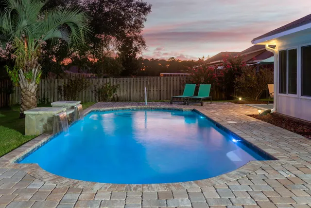a view of a swimming pool with an outdoor seating