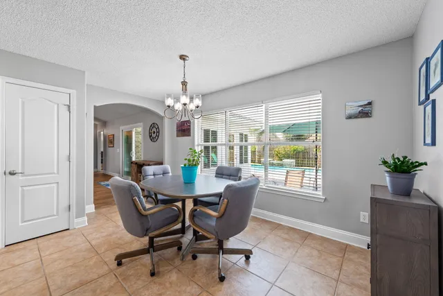 a living room with furniture a dining table and a flat screen tv