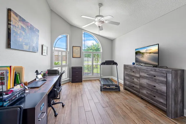 a spacious bedroom with a bed and a dresser