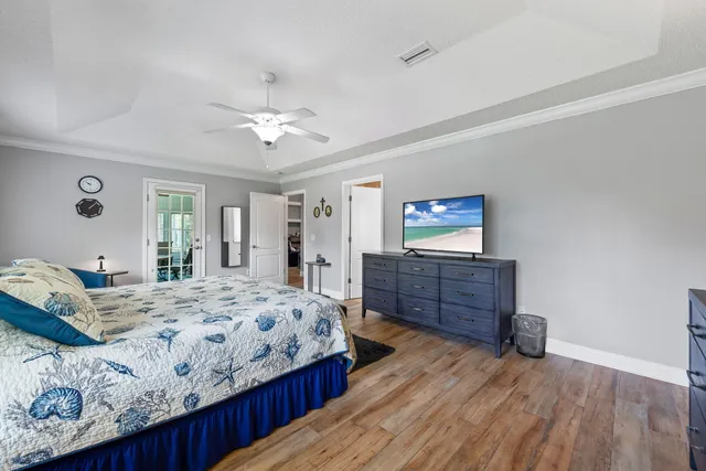 a view of backyard with seating space and wooden fence