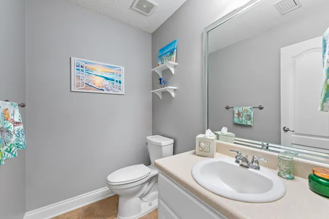 a view of a chair and table in backyard of the house