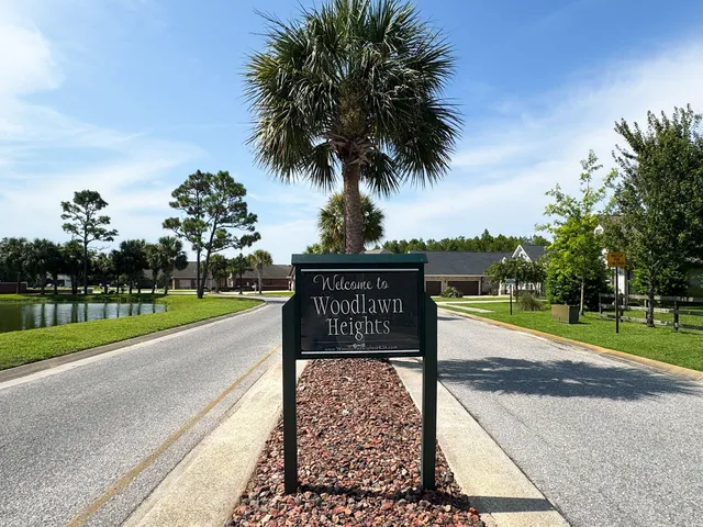 a front view of a house with a garden and yard