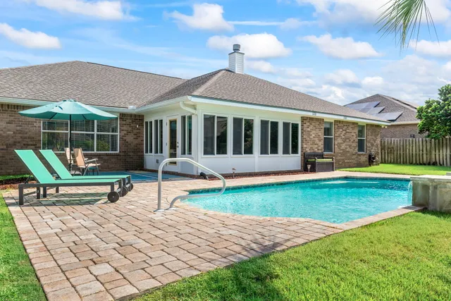 a view of a swimming pool with a patio