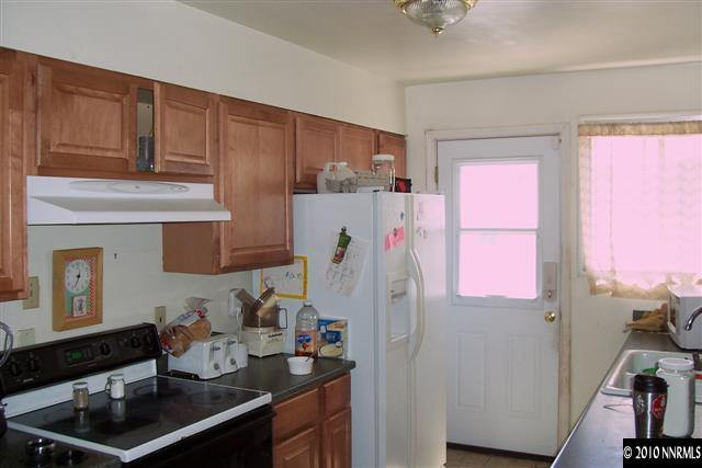 11150 Rocky Mountain Street Reno, NV 89506 - Photo 3 of 9 a room with furniture a refrigerator and a window