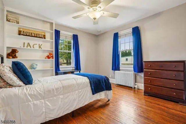 a bedroom with a bed mirror and window