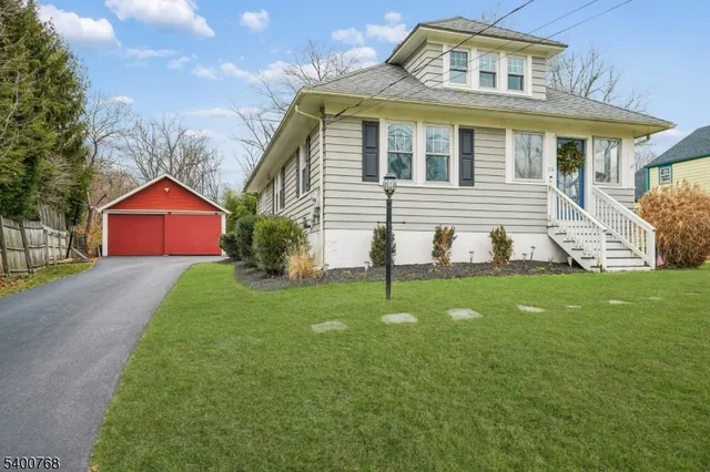 a aerial view of a house next to a big yard and large trees