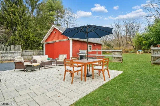 a view of a table and chairs under an umbrella