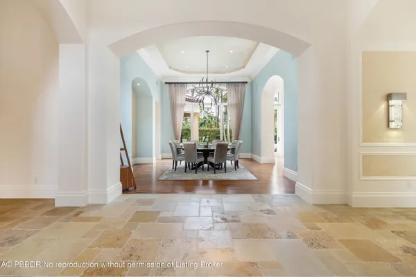 a kitchen with stainless steel appliances kitchen island granite countertop a stove a sink and a white wooden cabinets