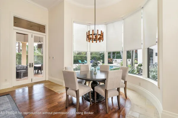 a room with pool table and windows
