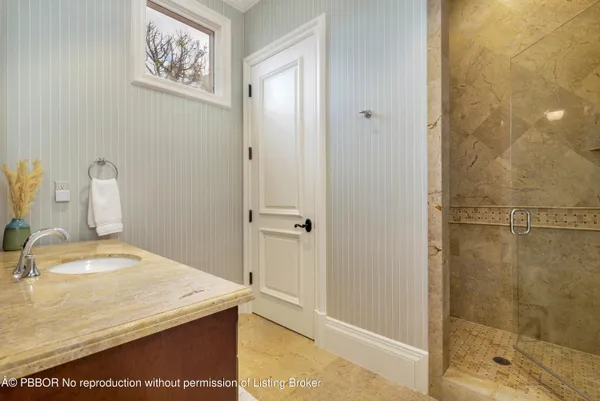 a bathroom with a granite countertop toilet sink and mirror