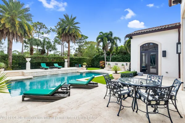 an aerial view of a house with a garden and swimming pool