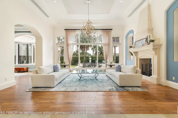 a living room with fireplace furniture and a chandelier