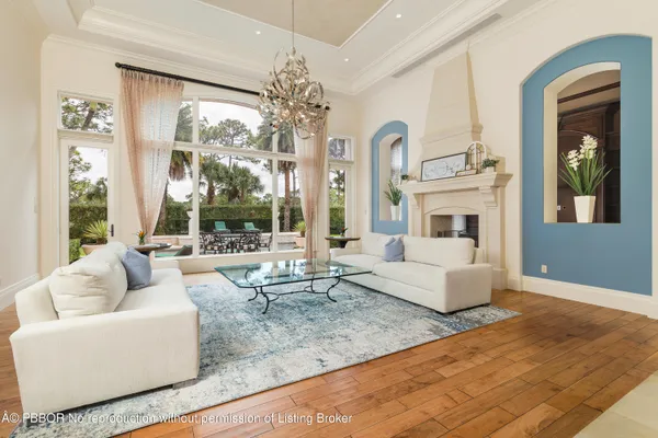 a living room with fireplace furniture and a large window
