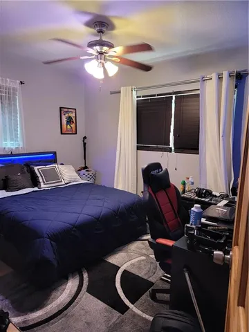 a bedroom with bed and a flat tv screen