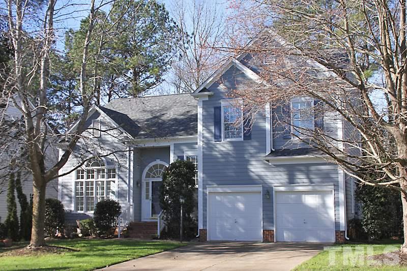 9021 Breeland Way Raleigh, NC 27613 - Photo 1 of 20 a front view of a house with yard and trees