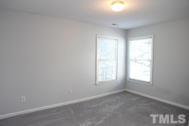 9021 Breeland Way Raleigh, NC 27613 - Photo 11 of 20 an empty room with windows and closet