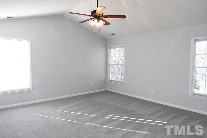 9021 Breeland Way Raleigh, NC 27613 - Photo 12 of 20 a view of room with a ceiling fan and window