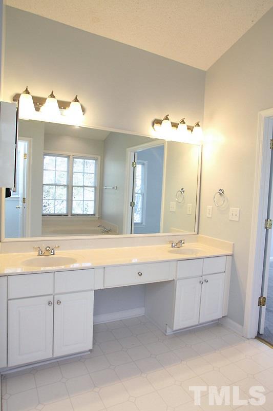 9021 Breeland Way Raleigh, NC 27613 - Photo 13 of 20 a spacious bathroom with a tub double sink and mirror