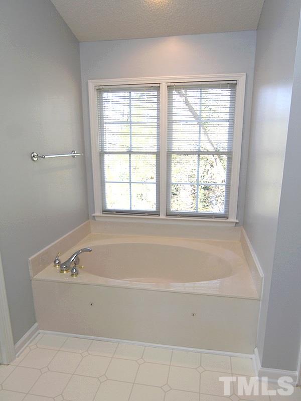 9021 Breeland Way Raleigh, NC 27613 - Photo 14 of 20 a bathroom with a bathtub