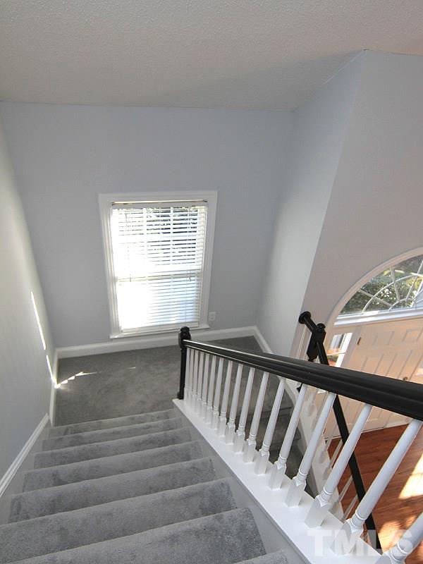 9021 Breeland Way Raleigh, NC 27613 - Photo 15 of 20 a view of entryway and hall with wooden floor