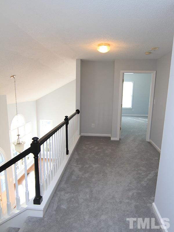 9021 Breeland Way Raleigh, NC 27613 - Photo 16 of 20 a view of a hallway with staircase