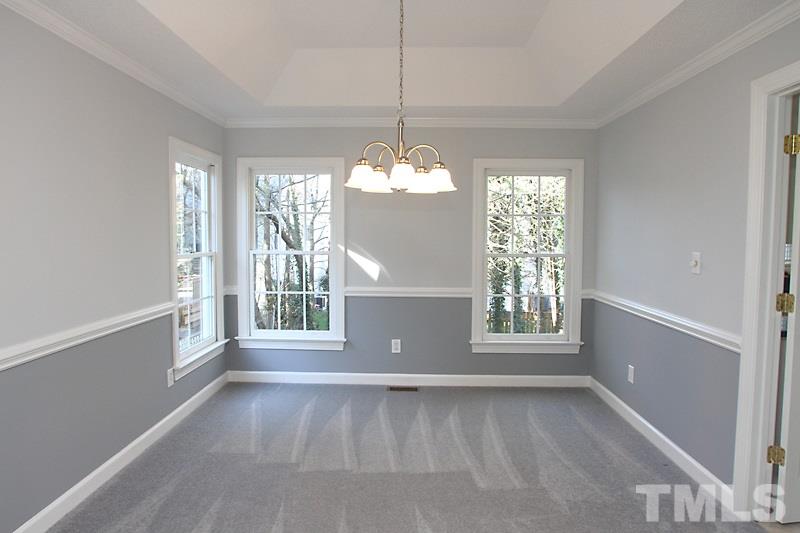 9021 Breeland Way Raleigh, NC 27613 - Photo 5 of 20 a view of a big room with windows and chandelier